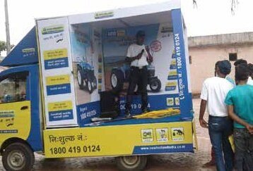 Branded toll-free helpline promotional kiosk on a mobile van