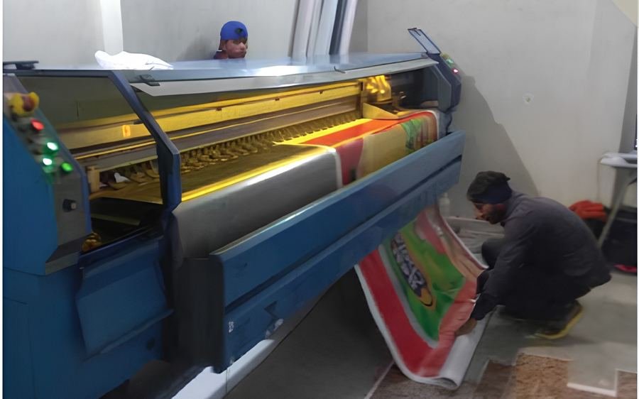 Large-format flex printing machine running a campaign banner in-house